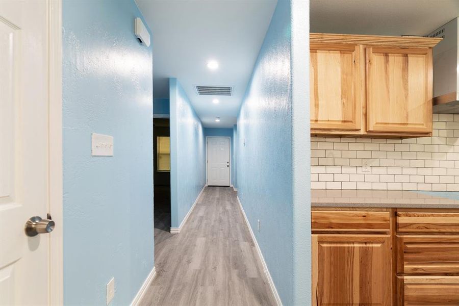 Corridor with light wood finished floors and recessed lighting Corridor with light wood finished floors and recessed lighting