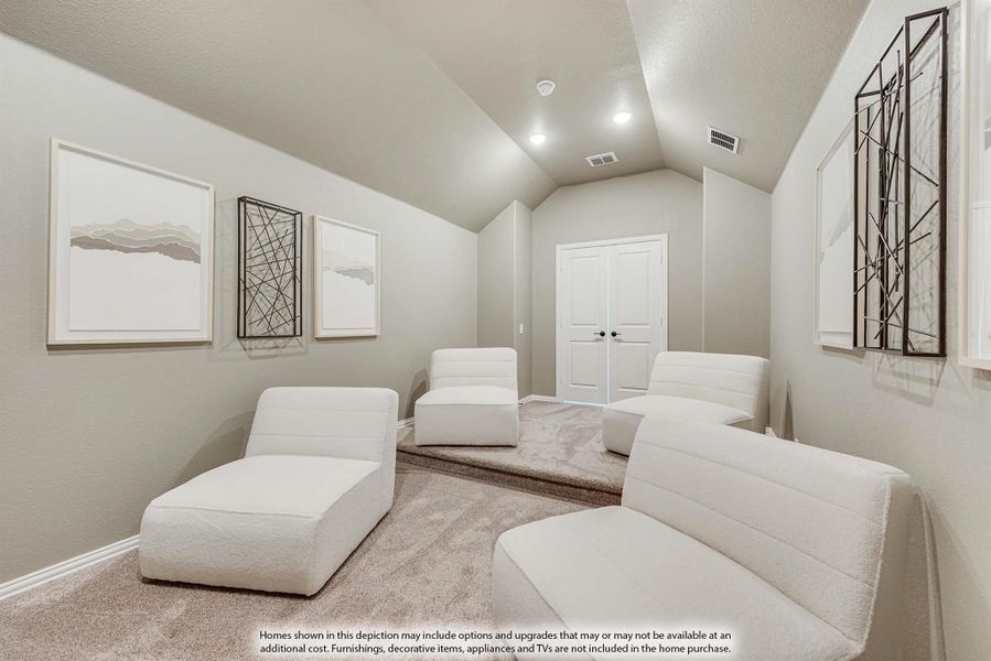 Media room with vaulted ceiling, carpet flooring, and four white lounge chairs facing double doors