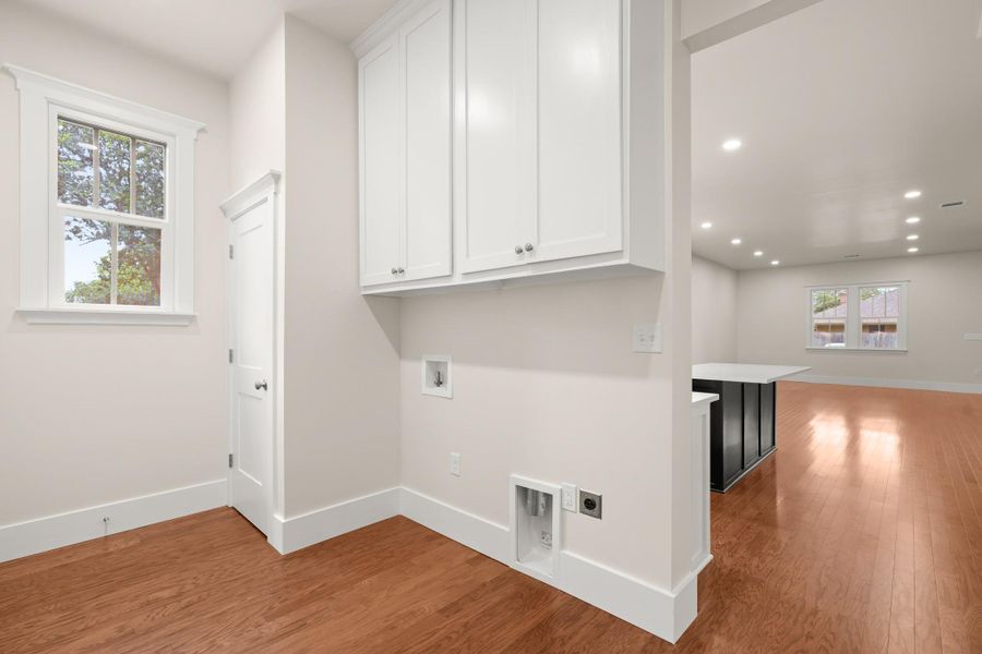 Integrated cabinetry provides practical storage in this well-appointed laundry area. Integrated cabinetry provides practical storage in this well-appointed laundry area.