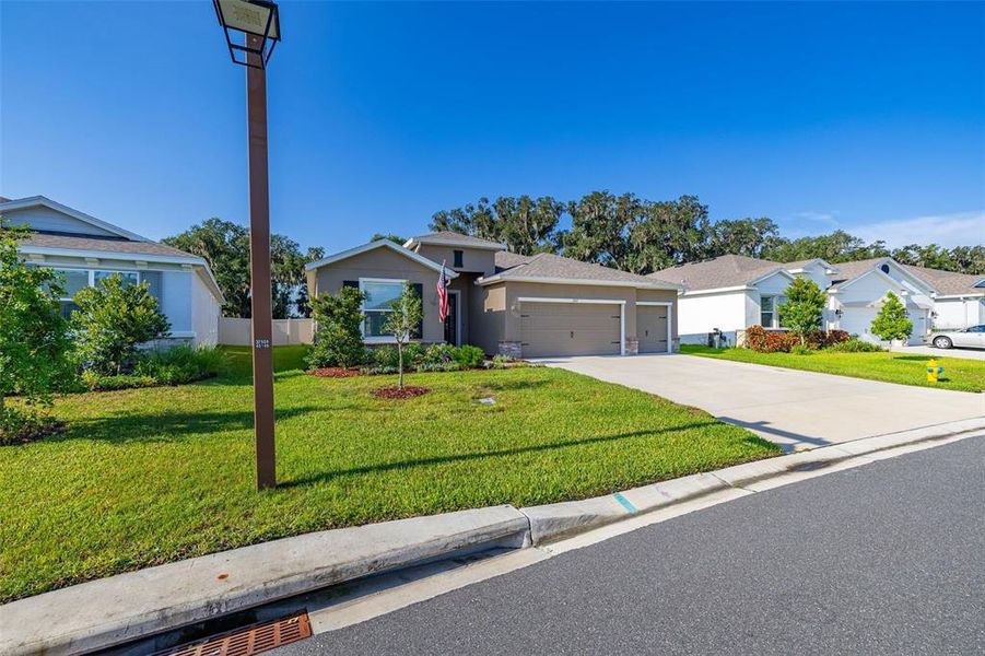 Front exterior of a new home in Farm at Varrea, Plant City, FL, highlighting curb appeal (Image 21). Front exterior of a new home in Farm at Varrea, Plant City, FL, highlighting curb appeal (Image 21).