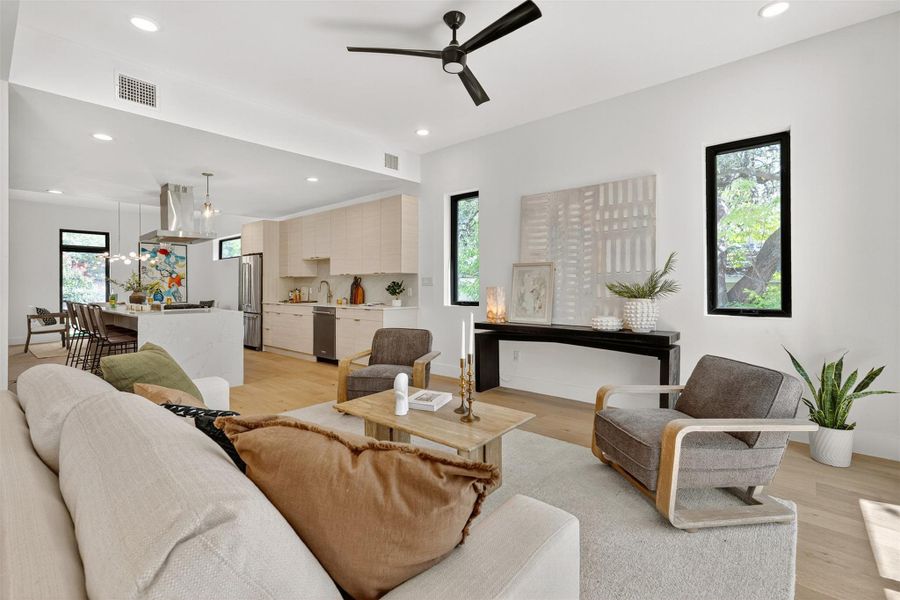 The living room’s open layout makes it effortless to host movie nights, game days, or cozy evenings, all while staying connected to the kitchen and dining areas The living room’s open layout makes it effortless to host movie nights, game days, or cozy evenings, all while staying connected to the kitchen and dining areas