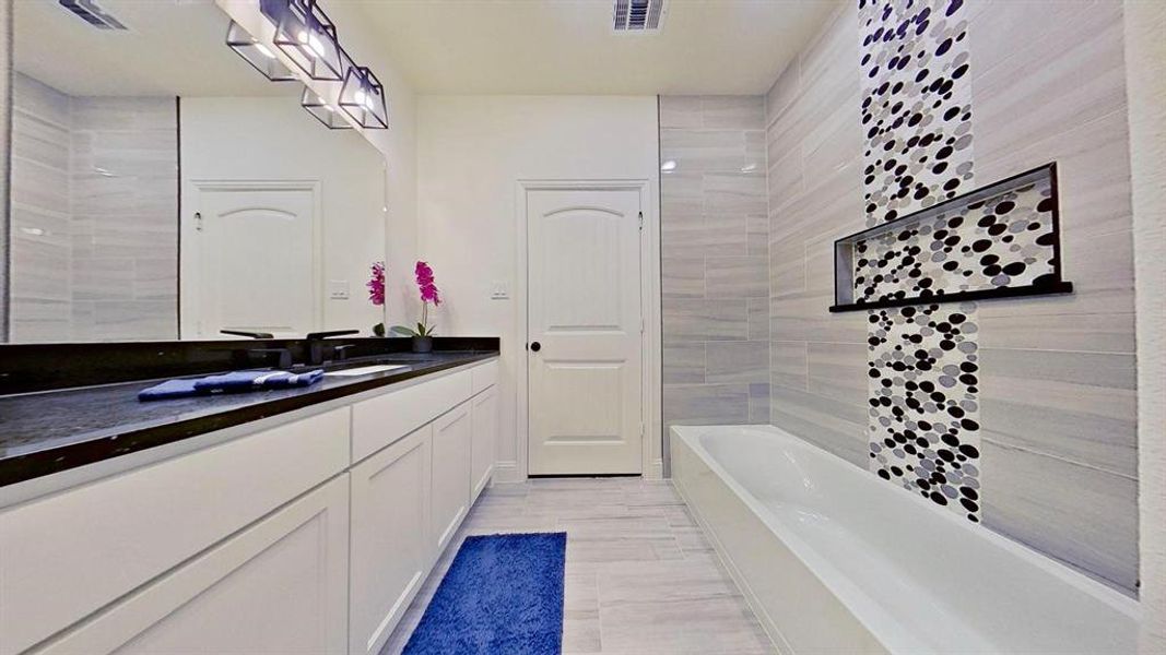 Full bath with vanity and a bath Full bath with vanity and a bath