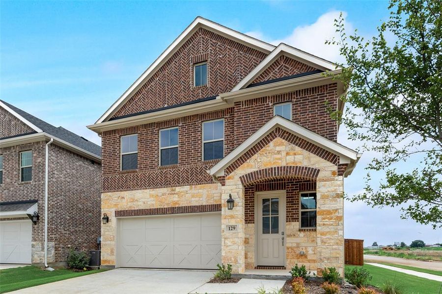 Front exterior of a new home in Spiritas Ranch, Little Elm, TX, highlighting curb appeal (Image 18).