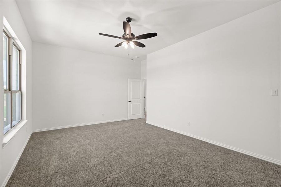 Downstairs bedroom with large walk in closet and ceiling fan Downstairs bedroom with large walk in closet and ceiling fan