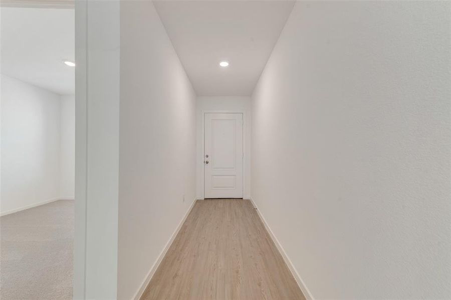 Hallway with light wood-type flooring