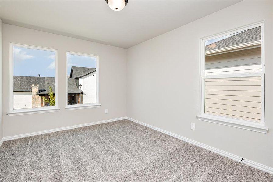Carpeted empty room with baseboards