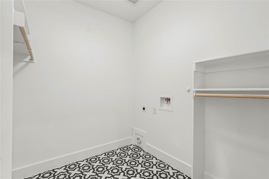 Washroom with hookup for a washing machine, electric dryer hookup, and tile patterned floors
