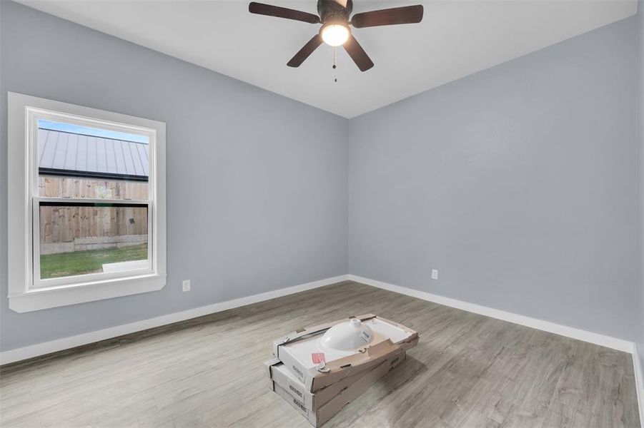 Unfurnished room with ceiling fan and wood finished floors