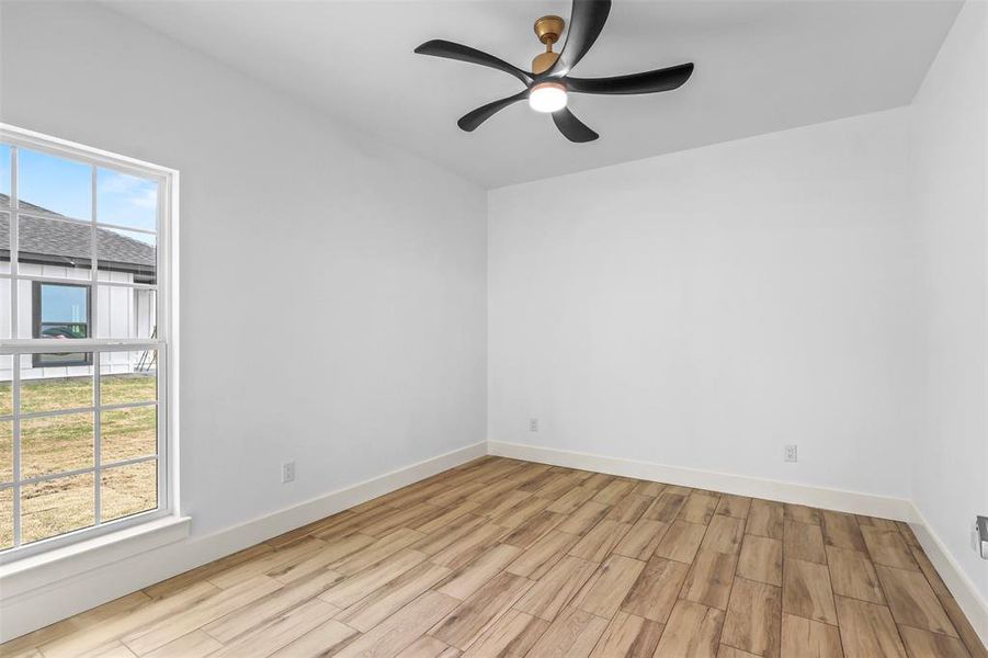 Empty room featuring wood finish floors and ceiling fan