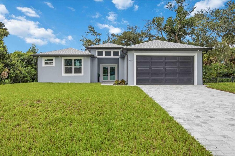 Front exterior of a new home in , North Port, FL, highlighting curb appeal (Image 2). Front exterior of a new home in , North Port, FL, highlighting curb appeal (Image 2).