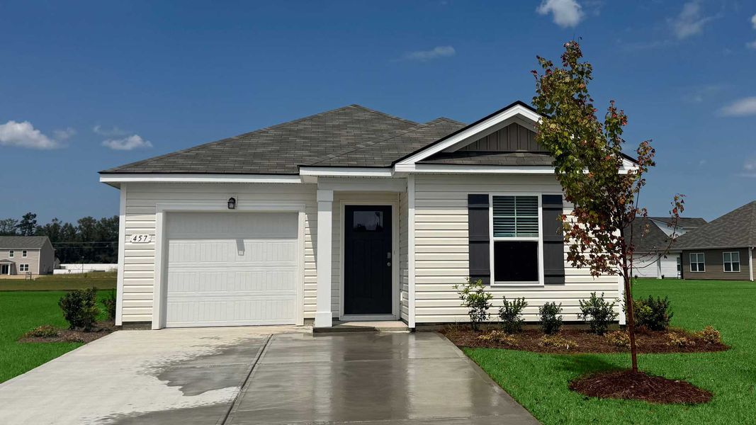 Front exterior of a new home in Heritage Crossing, Conway, SC, highlighting curb appeal (Image 1).