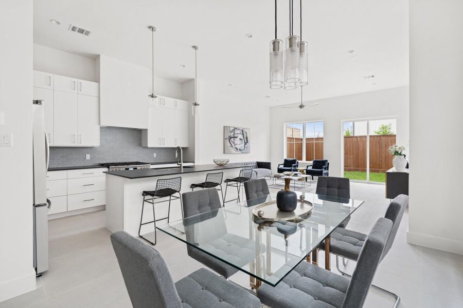 The dining area features a statement designer light fixture, adding elegance to every meal. The dining area features a statement designer light fixture, adding elegance to every meal.