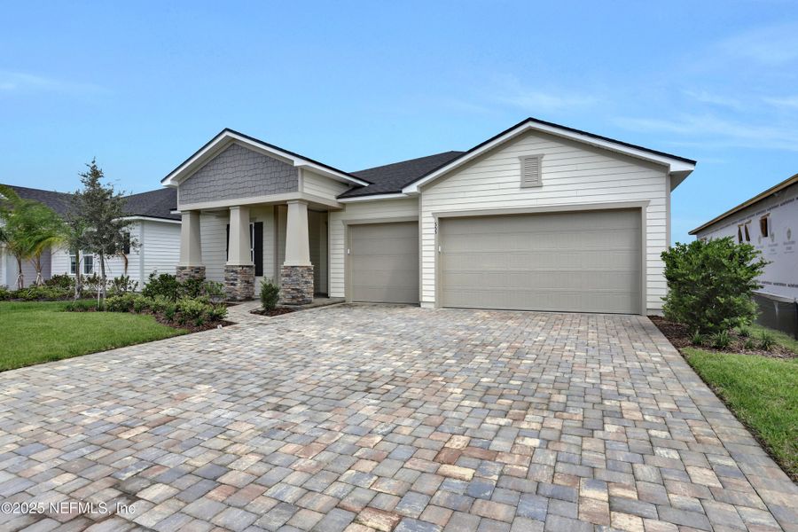 Front exterior of a new home in Reverie at Silverleaf, St. Augustine, FL, highlighting curb appeal (Image 13).