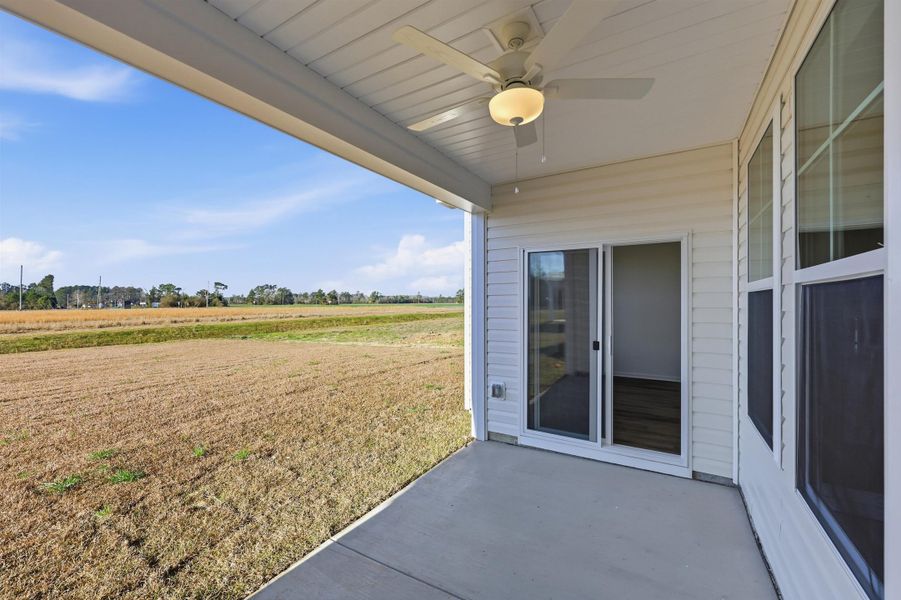 View of patio / terrace with ceiling fan, a view of rural / pastoral area, and agricultural plots