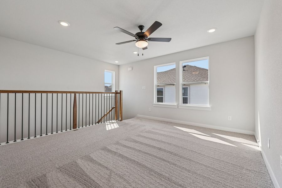 A room with a ceiling fan and a window.
