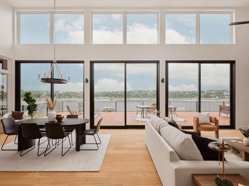 Expansive living area with high ceilings and wood-finish flooring