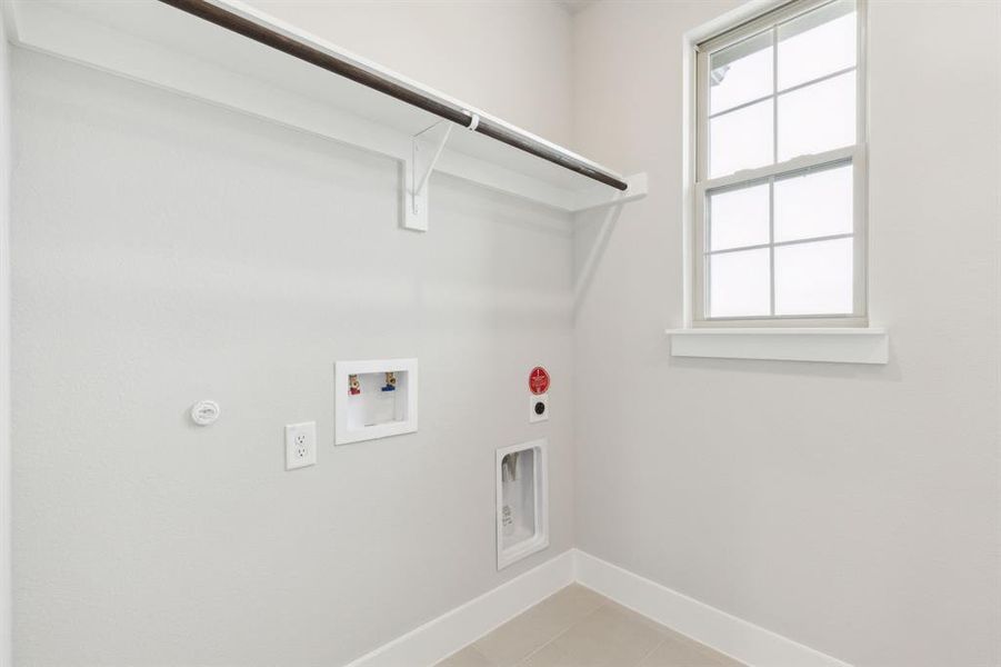 Laundry area featuring electric dryer hookup, washer hookup, plenty of natural light, and gas dryer hookup Laundry area featuring electric dryer hookup, washer hookup, plenty of natural light, and gas dryer hookup