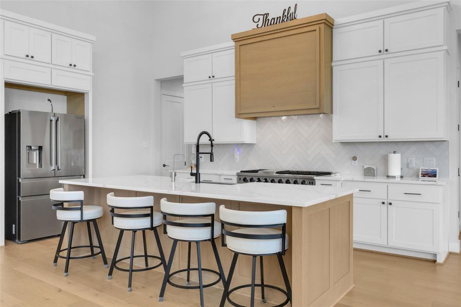 Chef's kitchen with oversized island and seating.