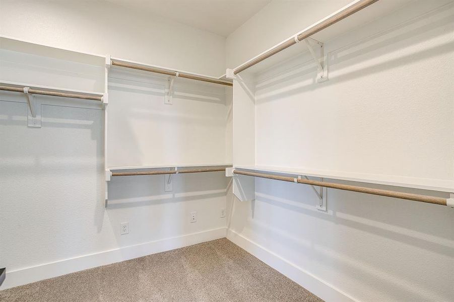 Walk in closet featuring light carpet