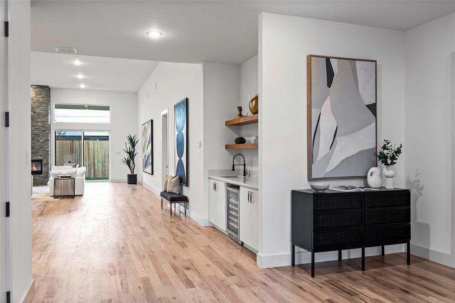 Hall featuring sink, light hardwood / wood-style floors, and beverage cooler