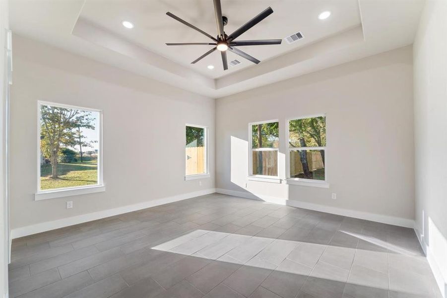 The primary suite of your dreams! Oversized ceiling fan for this Texas heat, picture windows with a view, TWO walk in closets and a spacious bathroom for you to get ready in the mornings and unwind in the evenings.