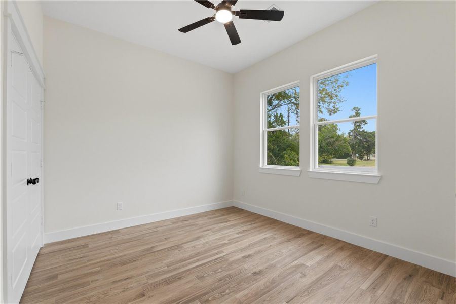 To the right of the entrance, you’ll find the first full bedroom, complete with a spacious closet. This versatile space can serve as a home office, game room, or guest room.