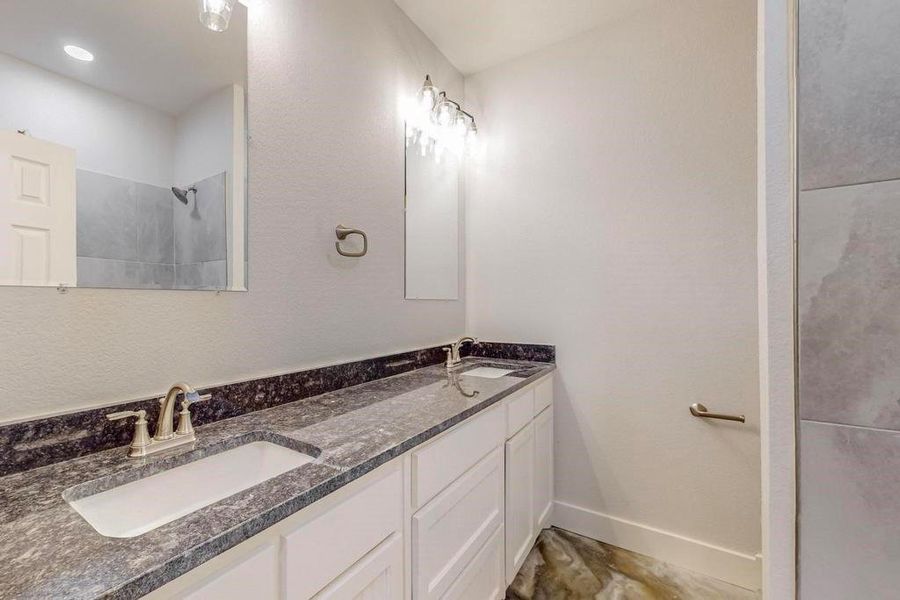 Bathroom featuring double vanity and tile patterned floors