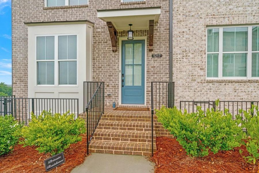 Exterior details and patio area of a home in Millcroft Townhomes, Buford (Image 3).