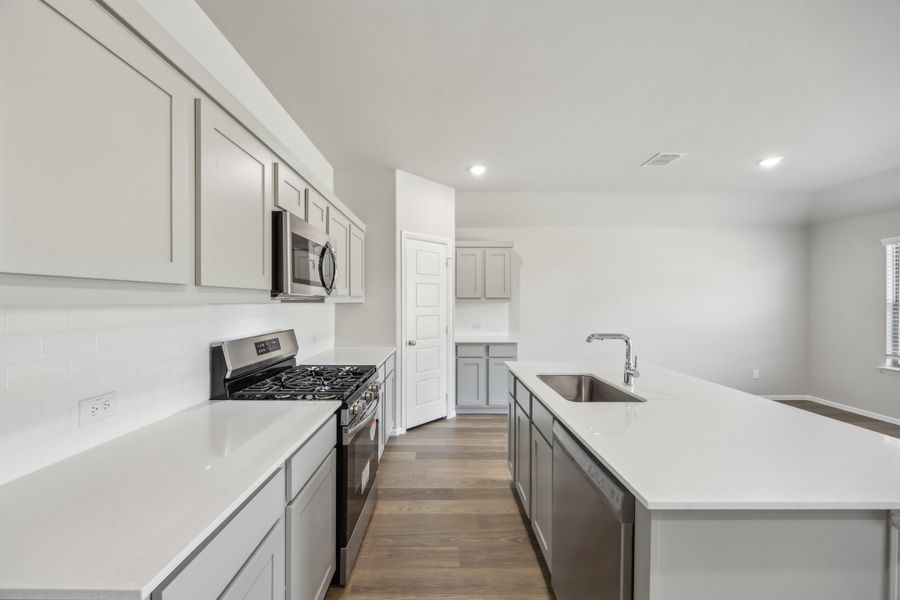 Kitchen in the Hadley home plan by Trophy Signature Homes – REPRESENTATIVE PHOTO