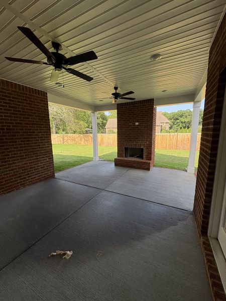 Jumbo covered patio featuring 2 ceiling fans and wood burning brick fireplace. Jumbo covered patio featuring 2 ceiling fans and wood burning brick fireplace.