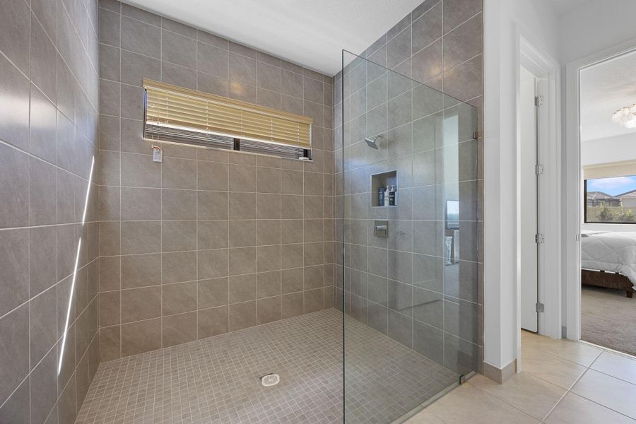 Bathroom with ensuite bath, a walk in shower, and tile patterned floors
