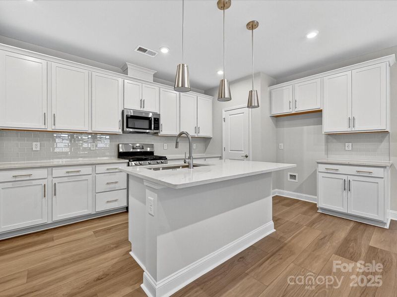 Striking White Cabinetry and Quartz Countertops.