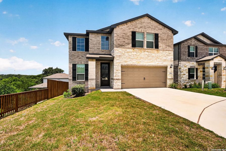 Front exterior of a new home in Thomas Pond, San Antonio, TX, highlighting curb appeal (Image 25).