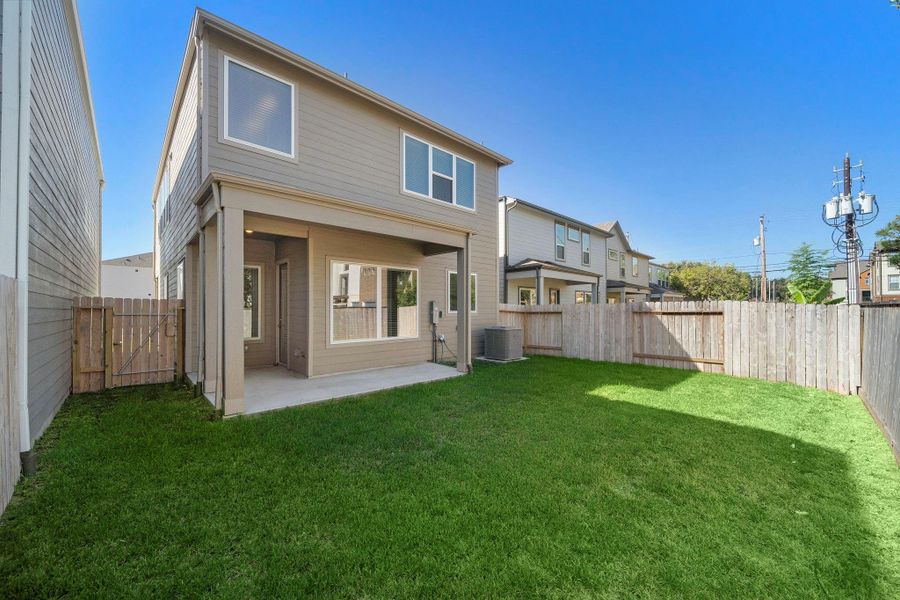 Surrounded by a wooden fence, this backyard offers a private retreat where you can relax and unwind.