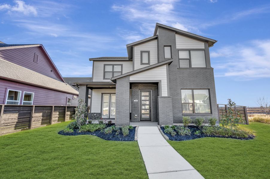 Front exterior of a new home in Indigo - Enclave Collection, Richmond, TX, highlighting curb appeal (Image 1). Front exterior of a new home in Indigo - Enclave Collection, Richmond, TX, highlighting curb appeal (Image 1).