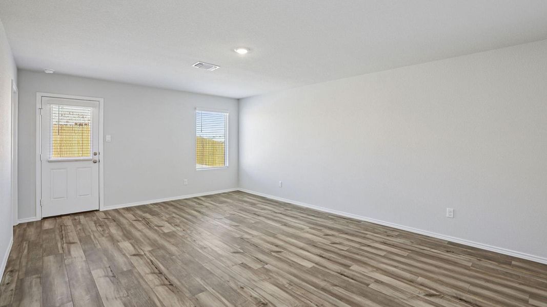 Spare room featuring light wood-type flooring and baseboards