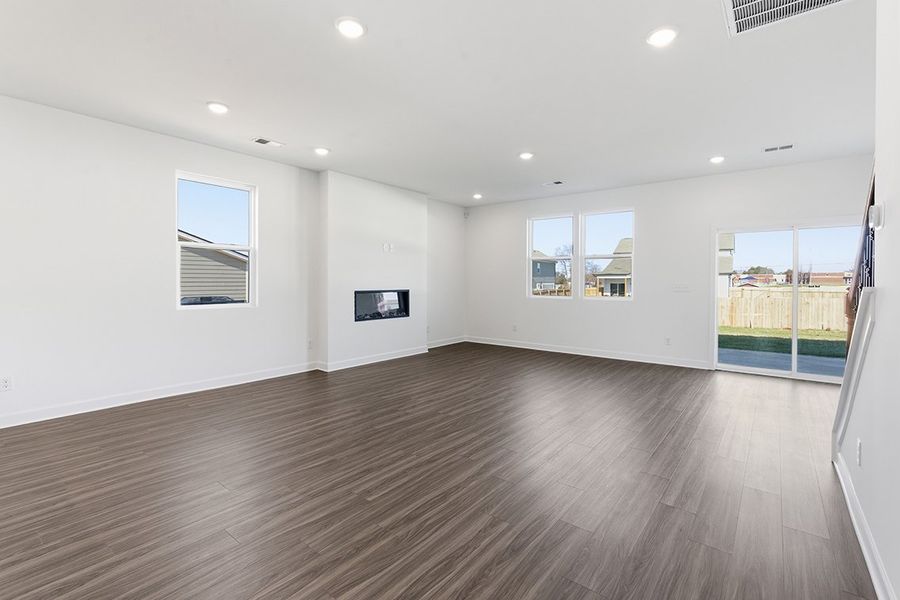 A room with a wood floor and windows.