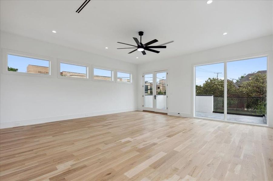 Unfurnished room featuring light hardwood / wood-style flooring and plenty of natural light