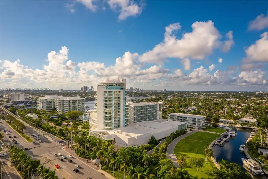 High-rise coastal development featuring tiered structural design, private balconies, expansive waterfront exposure, and integrated marina access High-rise coastal development featuring tiered structural design, private balconies, expansive waterfront exposure, and integrated marina access
