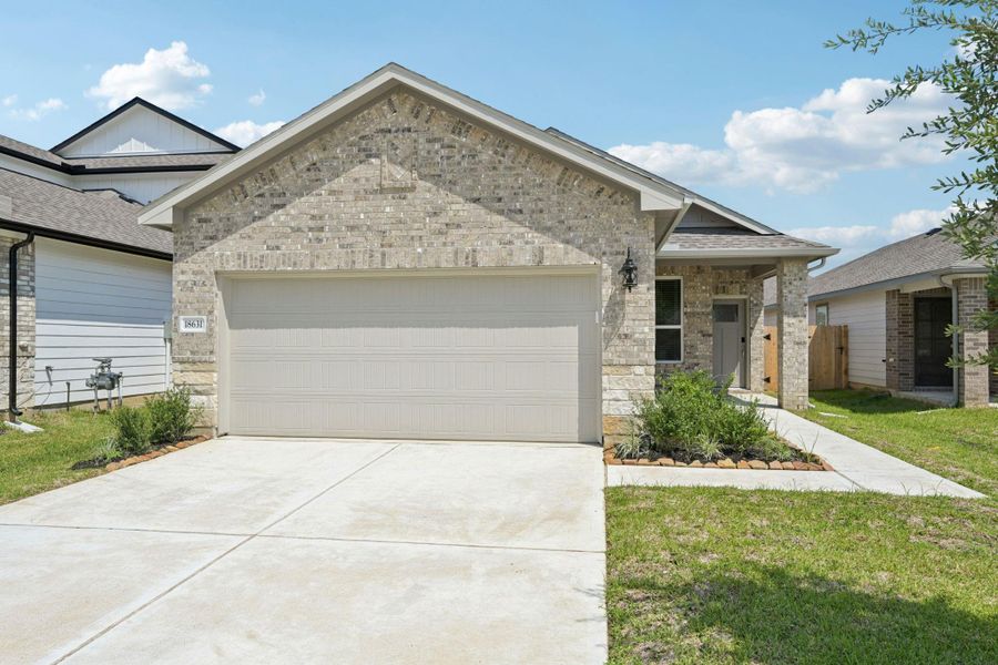 Front exterior of a new home in Landing Meadows - Traditional Series, New Caney, TX, highlighting curb appeal (Image 22).