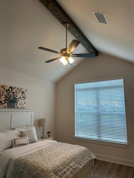 Vaulted ceiling featuring an exposed wood beam and a ceiling fan