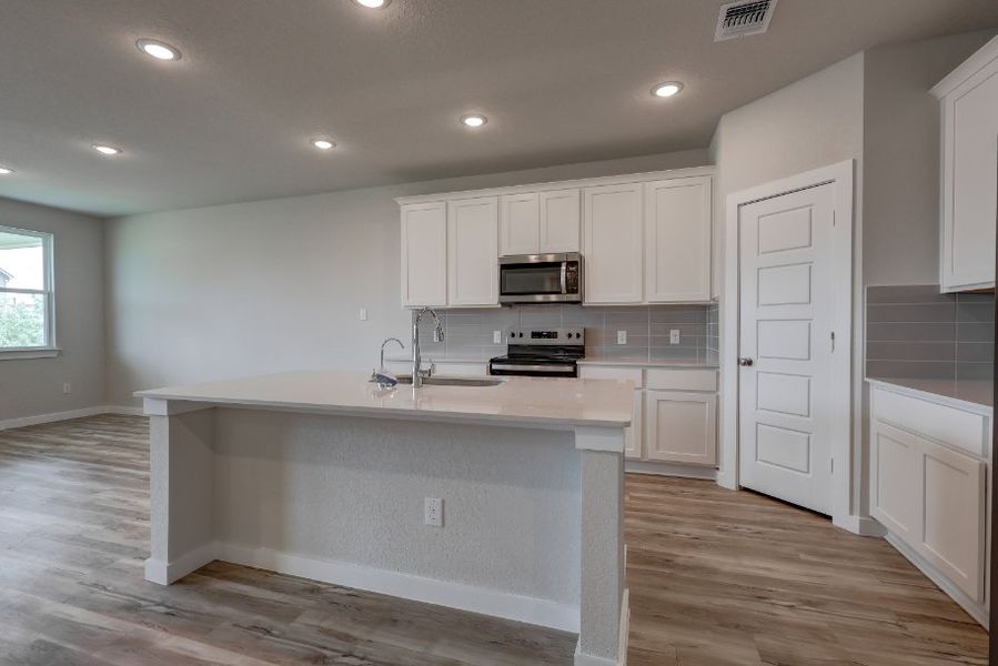 A kitchen with white cabinets. A kitchen with white cabinets.