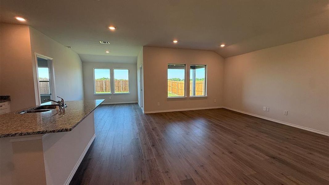 Open concept living area featuring wood-finish flooring and recessed lighting