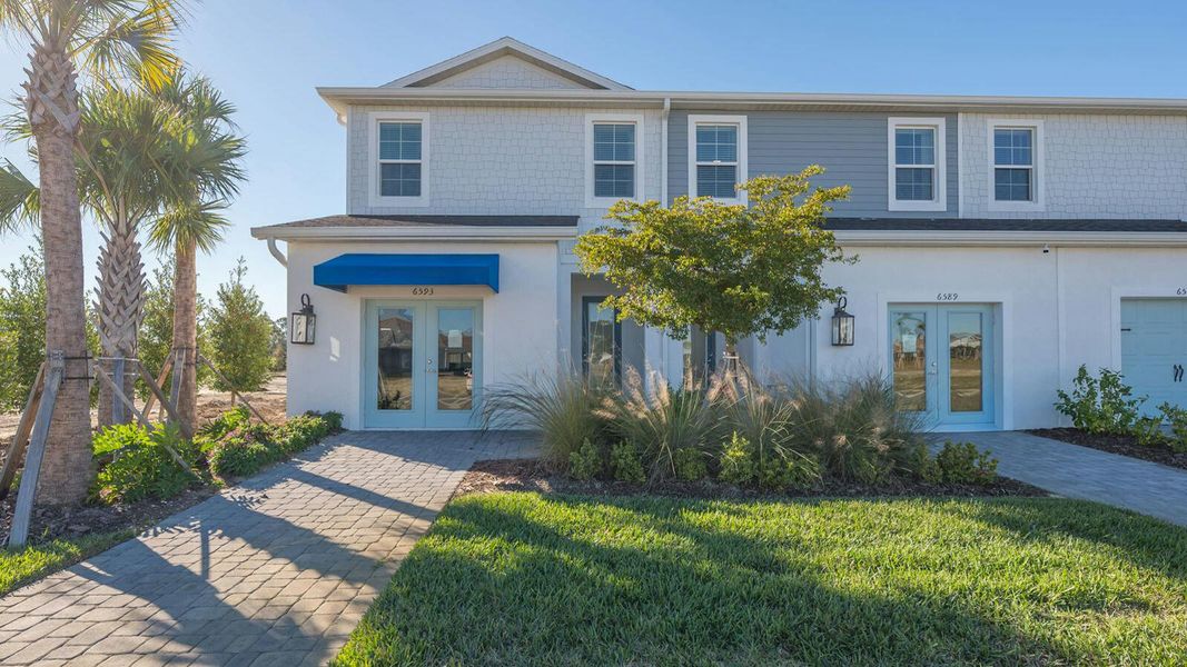 Front exterior of a new home in Grand Park Real Estate and Homes for Sale in Sarasota, FL - Neal Communities, Sarasota, FL, highlighting curb appeal (Image 2).