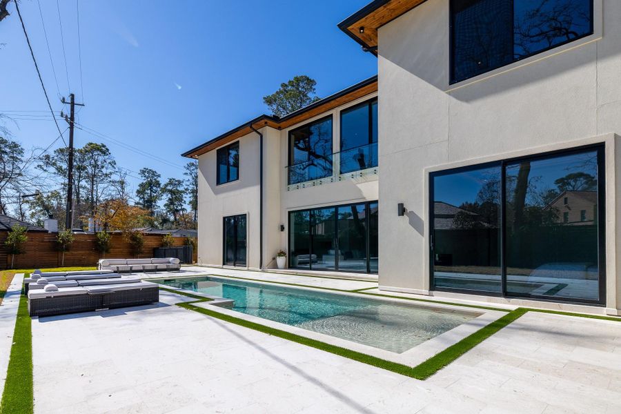 Pool and patio overlooking the rear elevation. Pool and patio overlooking the rear elevation.