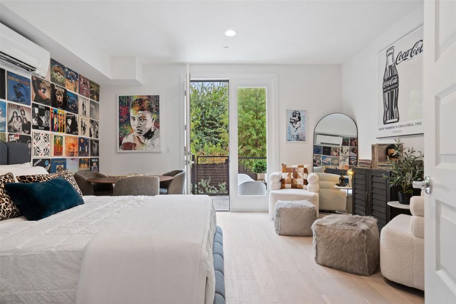 Bedroom with access to exterior, wood finished floors, a wall mounted AC, and recessed lighting