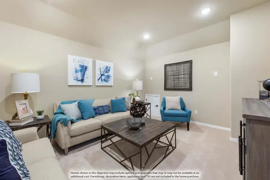 Living room with beige sofa, teal accent pillows, wood coffee table, and carpeted floors