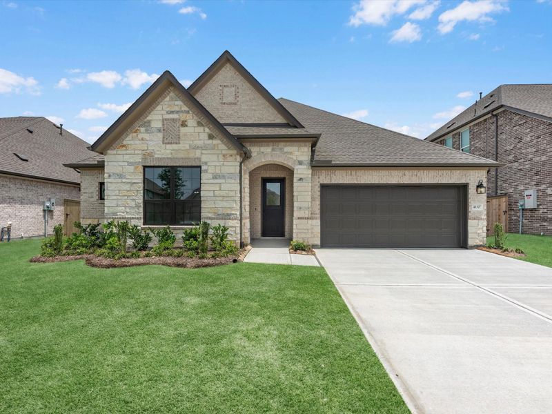Front exterior of a new home in Oakwood Estates, Waller, TX, highlighting curb appeal (Image 2). Front exterior of a new home in Oakwood Estates, Waller, TX, highlighting curb appeal (Image 2).