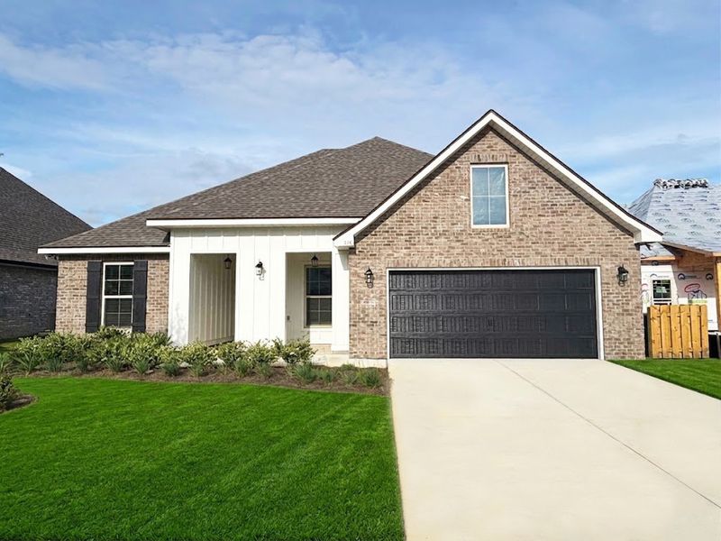 Front exterior of a new home in Bird Song at Hammock Bay, Freeport, FL, highlighting curb appeal (Image 1). Front exterior of a new home in Bird Song at Hammock Bay, Freeport, FL, highlighting curb appeal (Image 1).