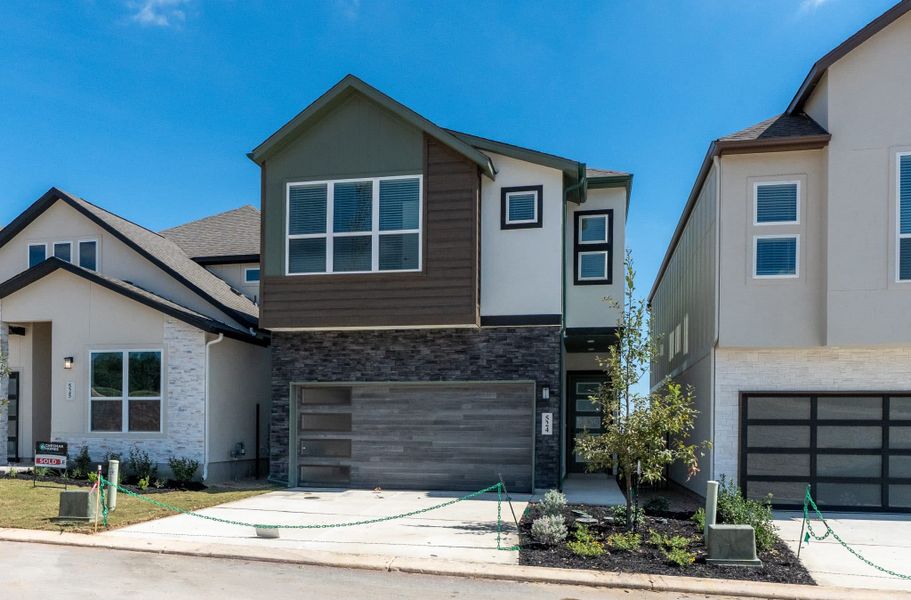 Front exterior of a new home in Centero at Stone Oak, San Antonio, TX, highlighting curb appeal (Image 20).